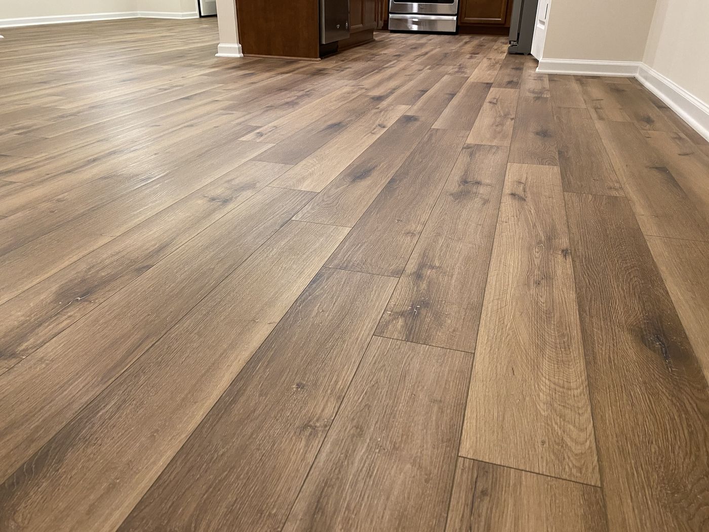 Luxury vinyl plank running from the living area into the kitchen