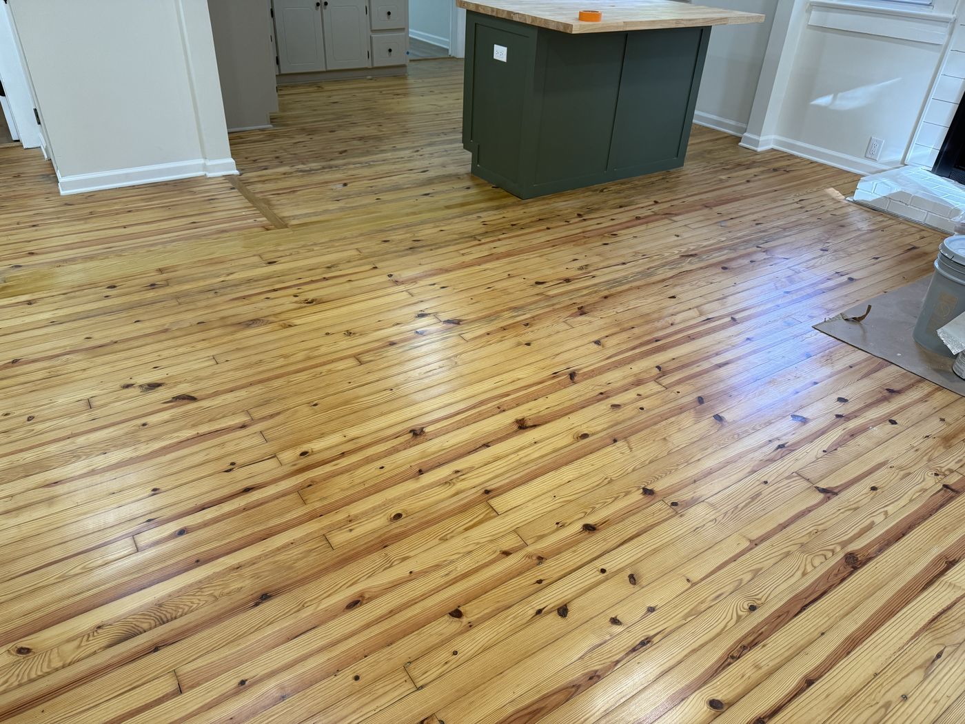 Refinished knotty wide-plank floor in a kitchen