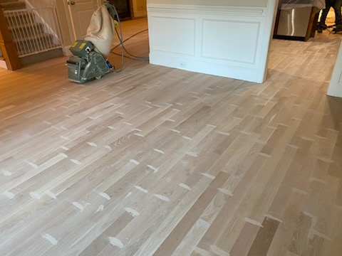 Oak floor sanded to bare wood with the drum sander still in the room
