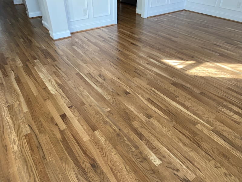 Refinished oak floor with sunlight across the grain