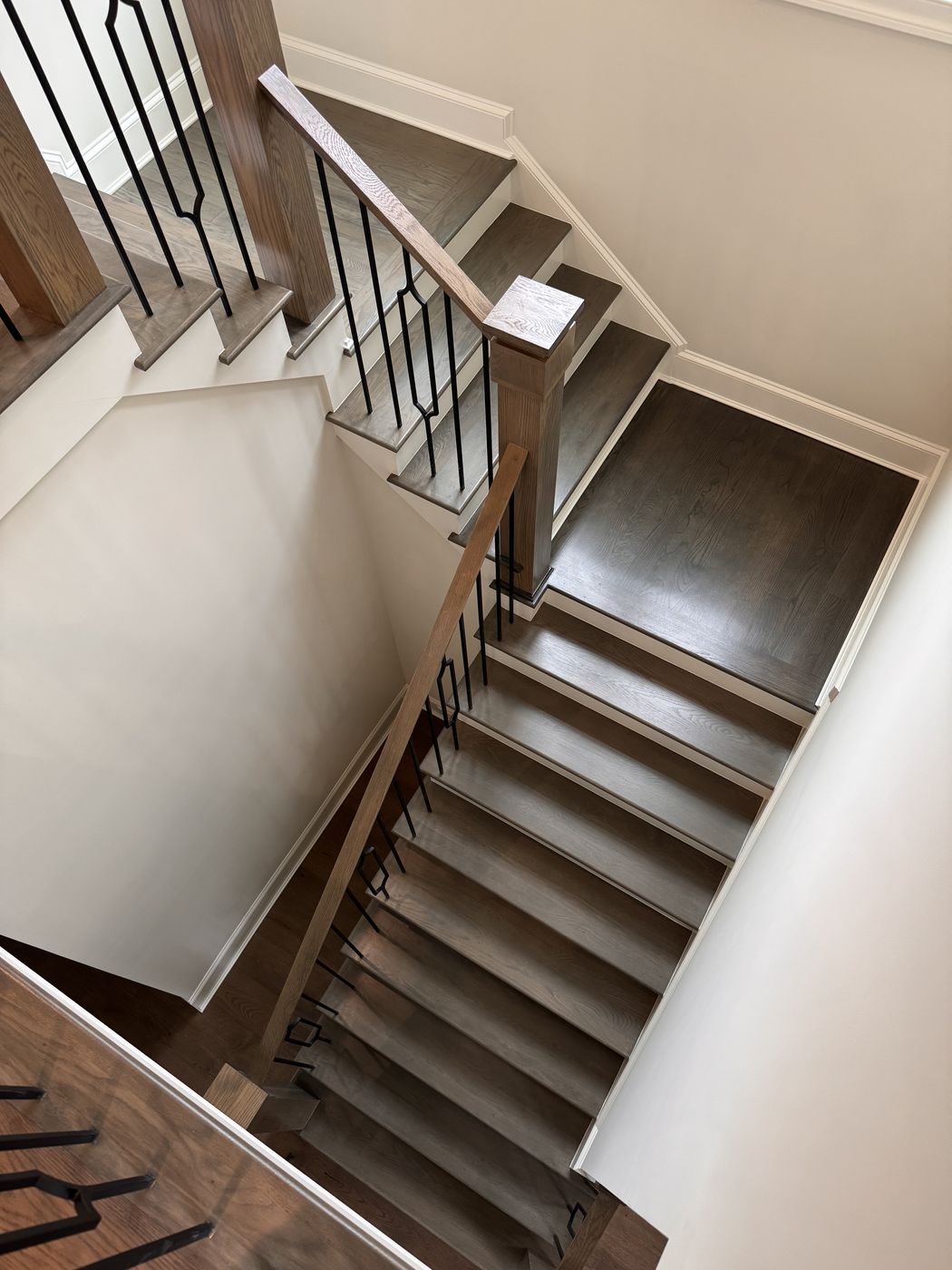 Switchback staircase with dark-stained treads and landing