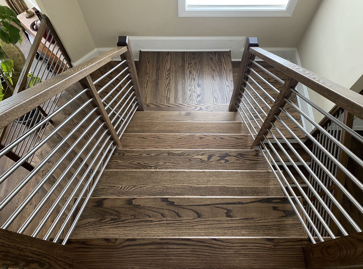 Split staircase with hardwood landing and horizontal rails